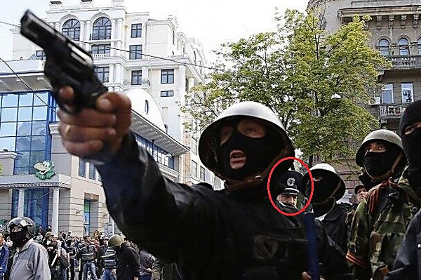 Russian separatist shoots at Ukrainian activists on May 2, 2014 in Odesa. Pro-Yanukovych police support separatists.