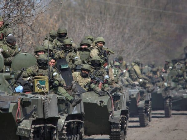 Service members of pro-Russian troops ride on armoured vehicles in the course of Ukraine-Russia conflict on a road leading to the city of Mariupol, Ukraine April 15, 2022. REUTERS/Chingis Kondarov NO RESALES. NO ARCHIVES